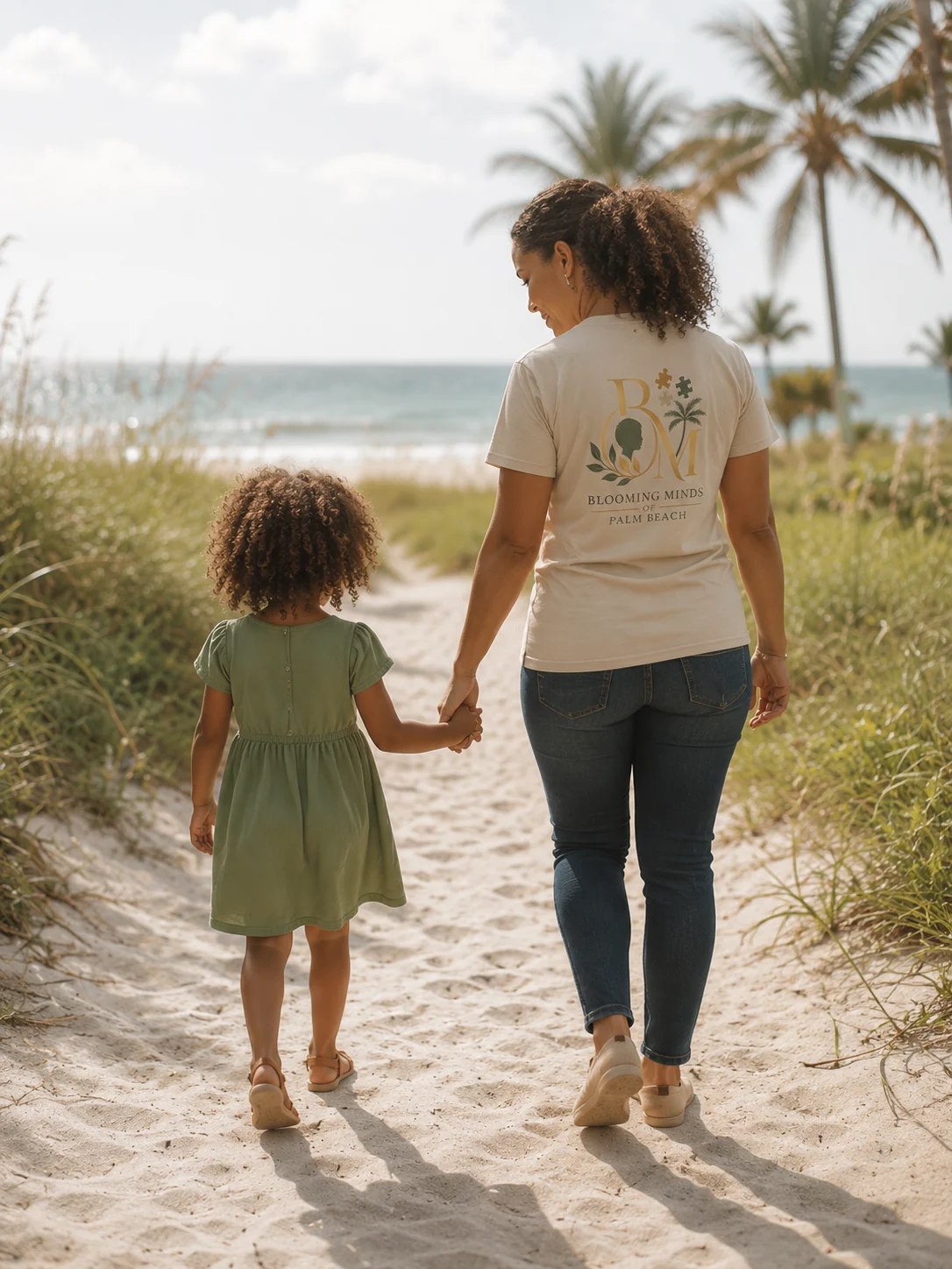 Representative photo of a caregiver and child walking together on a Palm Beach beach path